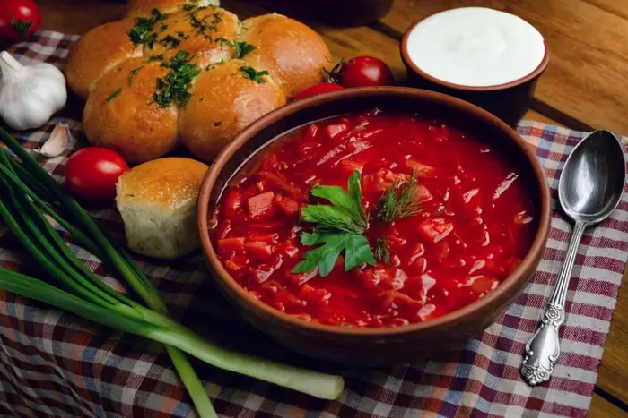 Young people eating borscht