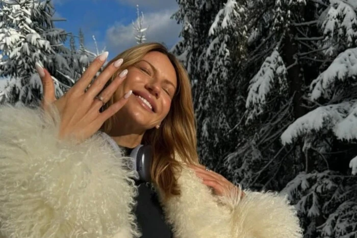 Freshly minted bride Lesya Nikityuk against a backdrop of flowers