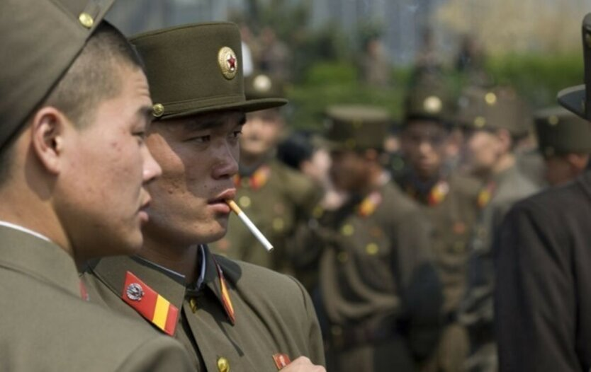 DPRK soldiers lie on the ground