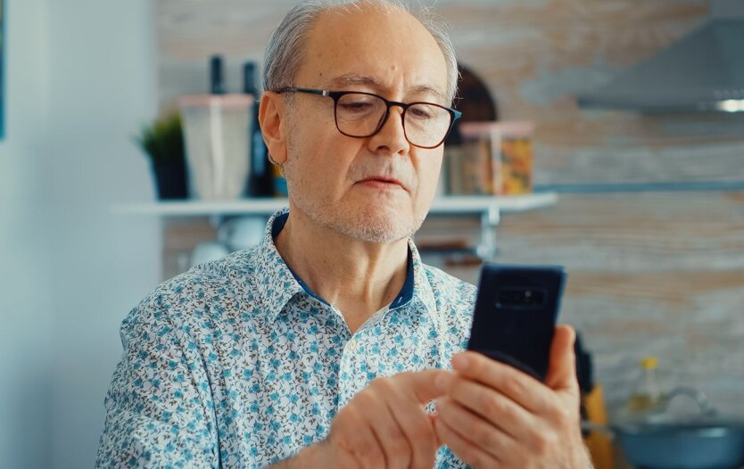 An elderly person collects money from the account